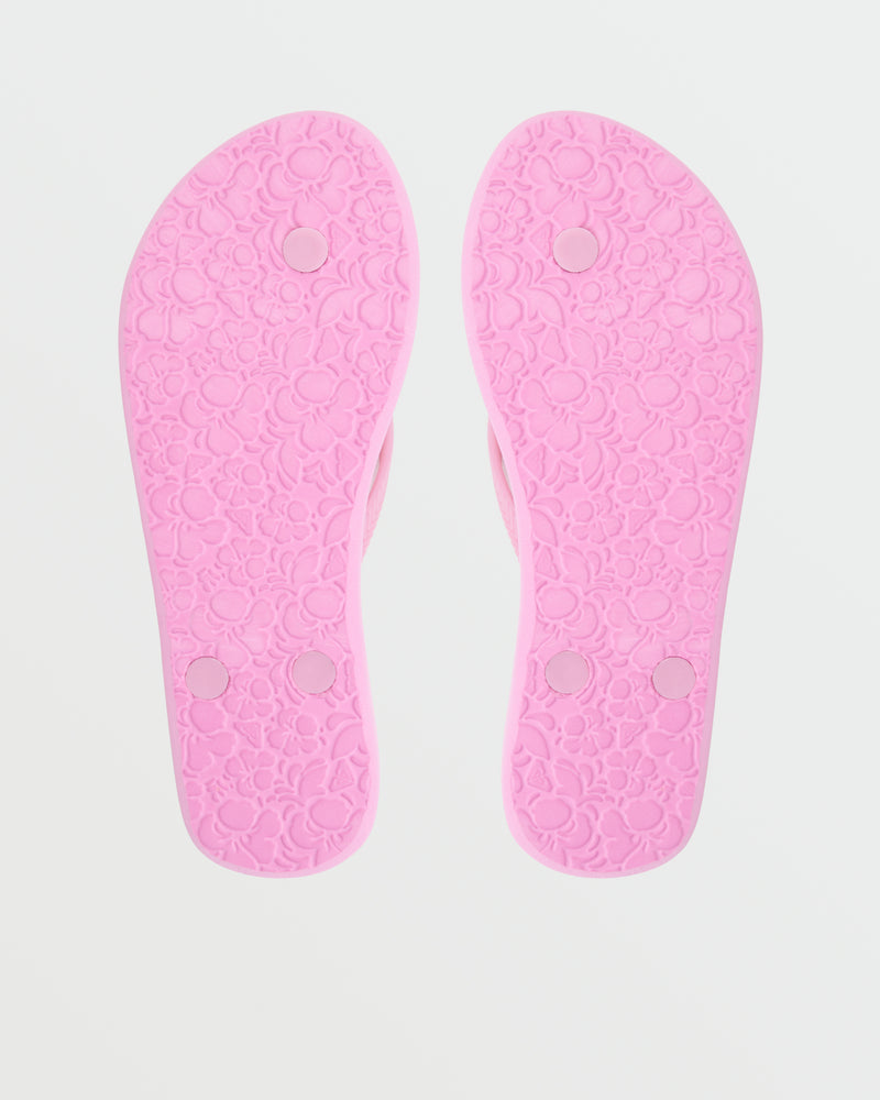 The Roxy Antilles II Sandal in pink is shown from the bottom, displaying floral patterns and four round grip pads on each sole for enhanced comfort.