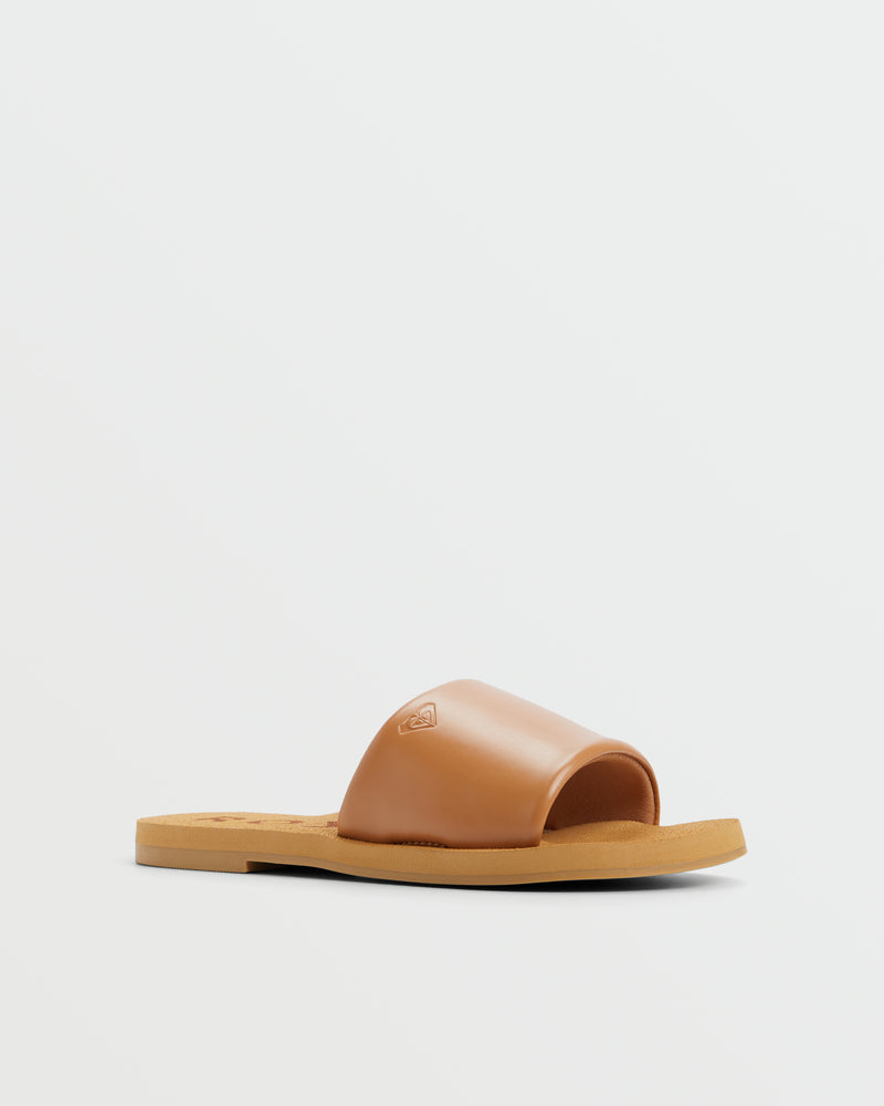 The Roxy Amalfi Coast Slide Sandal is a tan leather, open-toe, slide-on shoe with a flat sole, displayed against a plain white background.