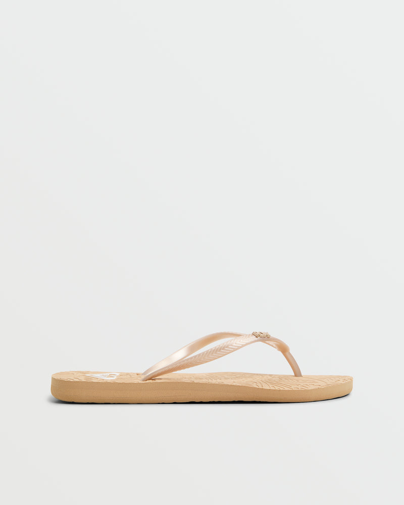 The Roxy Antilles II Sandal features a tan textured sole and light beige glossy thong straps, shown in profile on a white background—ideal for anyone seeking stylish comfort in beach sandals or flip flops.