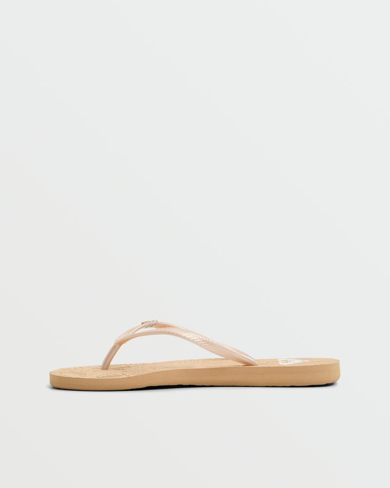 The Roxy Antilles II Sandal is a beige flip flop with thin straps and a flat sole, shown in side profile against a white background—ideal for anyone looking for comfortable, stylish beach sandals.