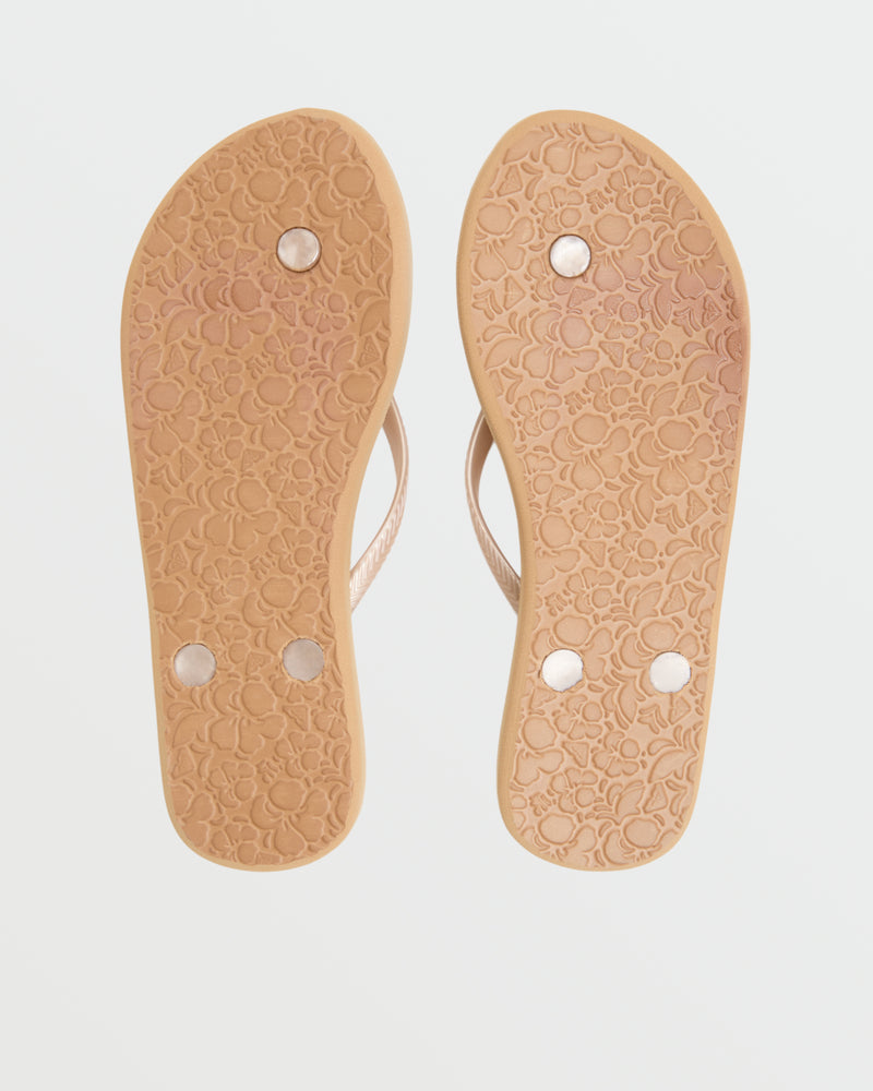 The image shows the bottoms of two beige Roxy Antilles II Sandals with floral-patterned soles and four round metallic studs on each sole.