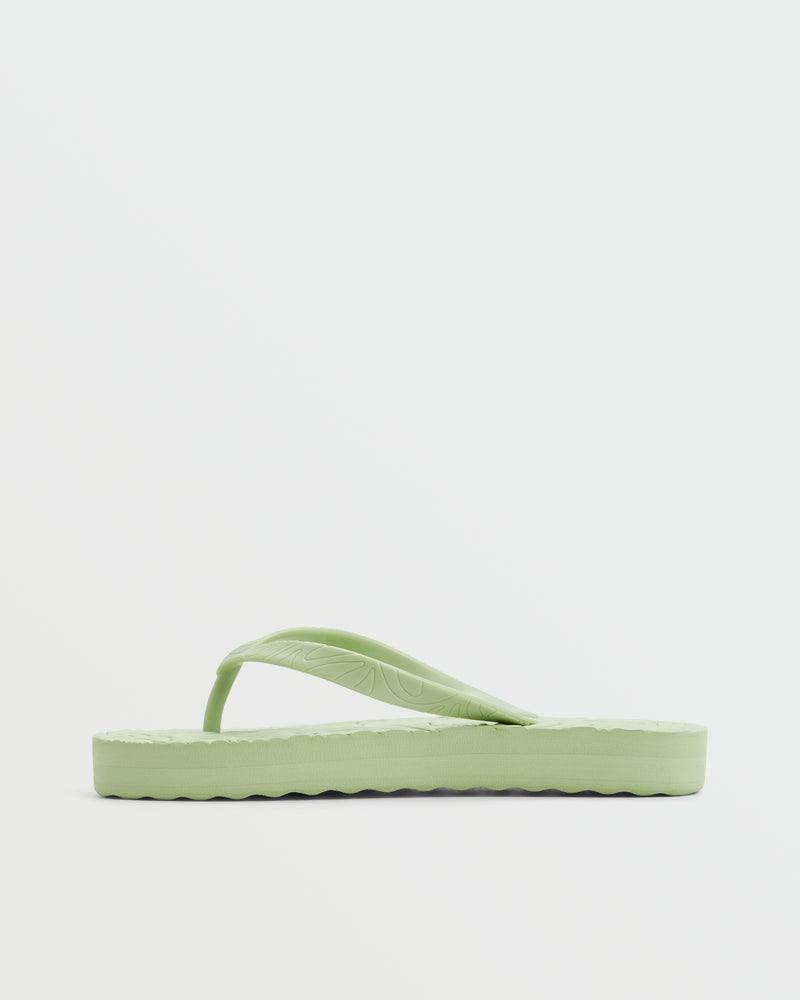 The Roxy Beach Up Sandal is a light green platform sandal with textured soles and simple straps—ideal for the beach and shown on a plain white background.