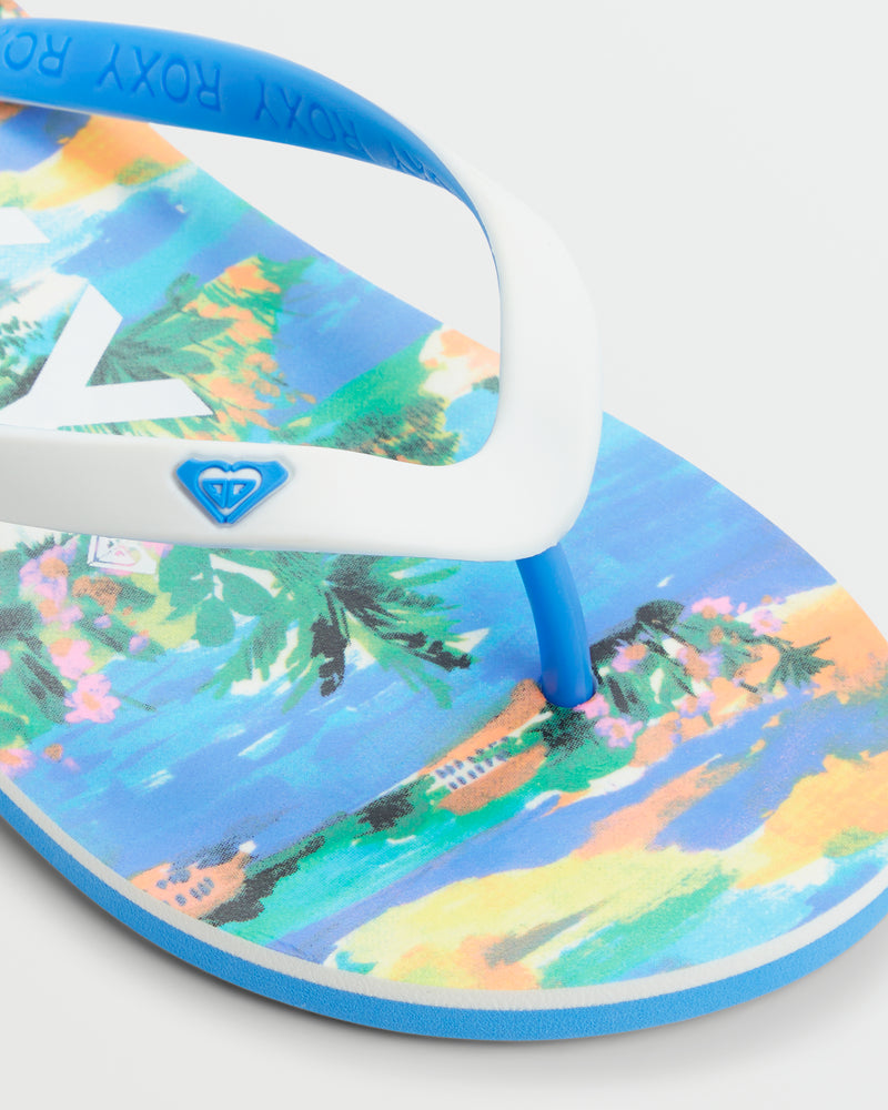 A close-up of the comfy Roxy Tahiti VII Sandal, showcasing a tropical beach and palm tree sole, white and blue straps, and a small blue heart logo—perfect for summer.