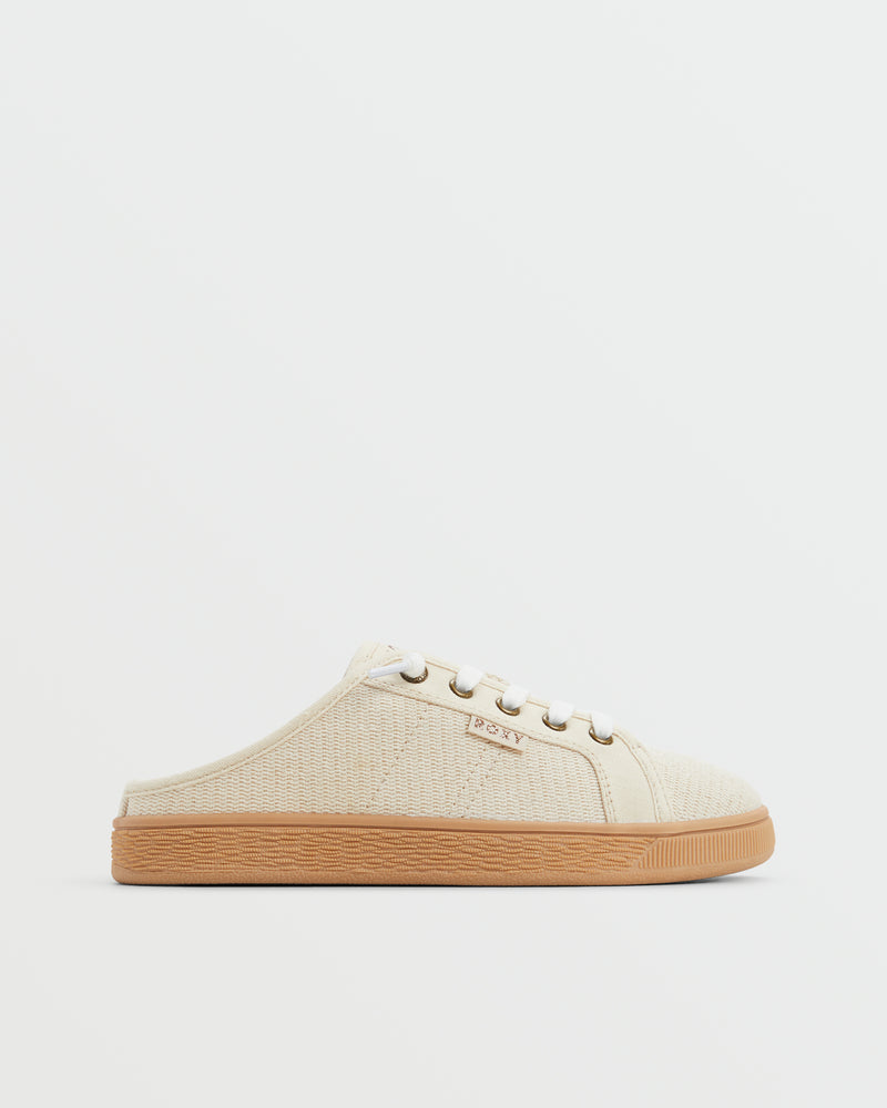 The Roxy Sunny Stroll Mule Sneaker is a cream-colored slip-on with white laces, a textured fabric upper, and a light brown rubber sole, shown in profile against a plain white background.