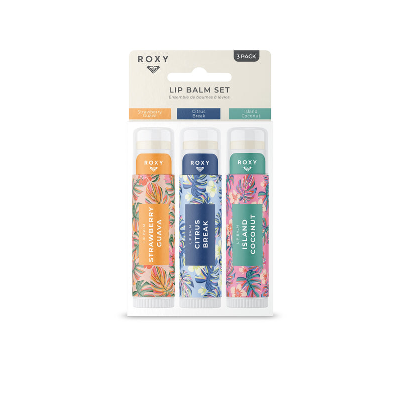 The Roxy Lip Balm Set includes three tropical flavors—Strawberry Guava, Citrus Break, and Island Coconut—in a white floral-themed package, each tube featuring vibrant designs for nourishing hydration.