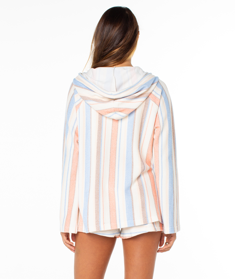 A woman is seen from the back wearing the Roxy Wild And Free Hoodie with matching shorts, featuring relaxed fit and summery blue, peach, and white stripes, against a plain white background.