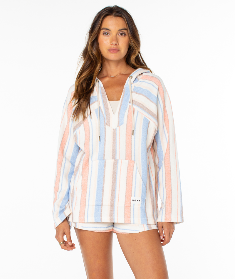 A woman faces forward in the Roxy Wild And Free Hoodie and matching shorts, featuring relaxed fit, summery pastel stripes, a front pocket, and breezy coastal vibes. The background is plain white.