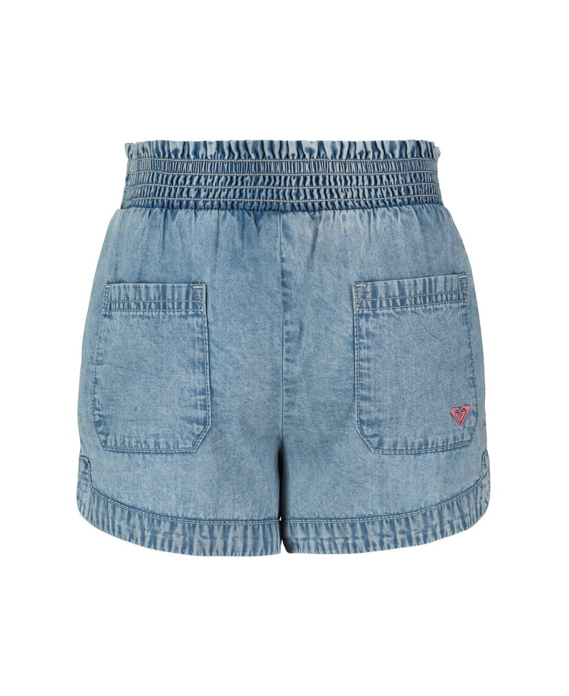 The Roxy Little Girls' Soleil Short features lightweight light blue denim, a smocked elastic waistband, two back pockets, and a small pink logo on the lower right pocket. The shorts are shown against a white background.