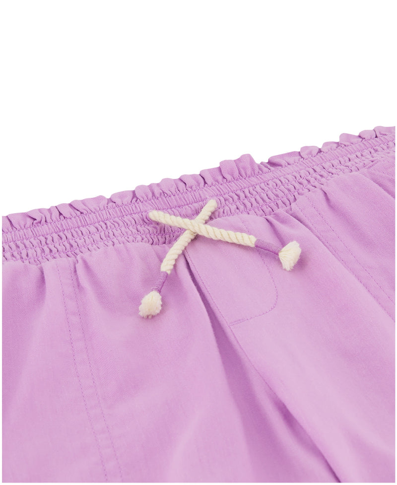 Close-up of the waistband on lavender Girls' Soleil Short by Roxy, featuring a smocked elastic top and a white twisted drawstring with knotted ends.