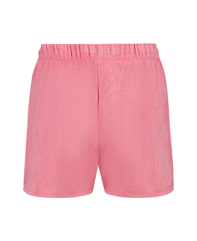 Back view of Girls' Sunset Short surf shorts by Roxy in pink, featuring an elastic waistband and soft baby French terry fabric, shown on a plain white background.