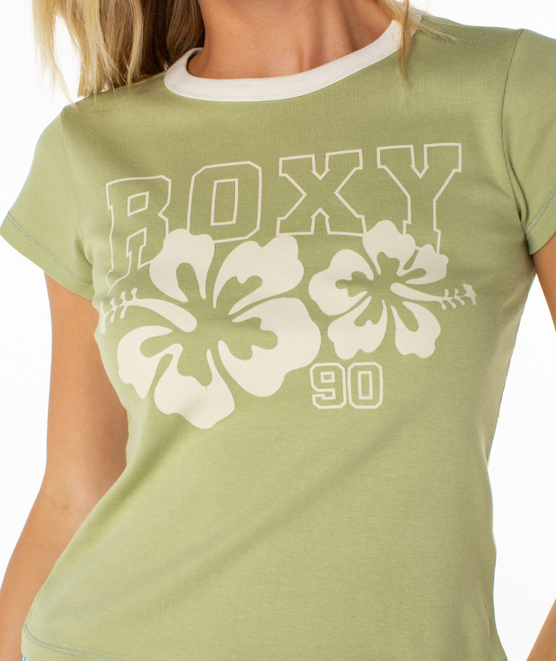 Sport the Roxy Genuine Hibiscus 90s Ringer Baby Tee—a light green, retro-inspired fitted top with white trim, ROXY text, hibiscus flowers, and “90” printed in white for a nostalgic look.