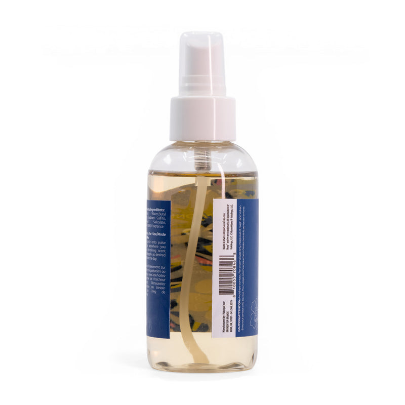 The Roxy Deep Dive Body Mist comes in a clear spray bottle with a white nozzle, filled with light yellow liquid and marine notes. A blue label with a barcode is on the back, displaying partially visible text against the white background.