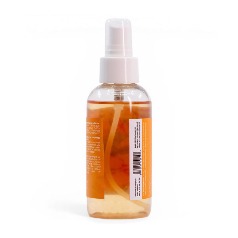 A clear plastic spray bottle of Roxy Sun Drift Body Mist with orange liquid and a white nozzle features an orange label hinting at refreshing guava and hibiscus scents; text and barcode appear on the back against a plain white background.