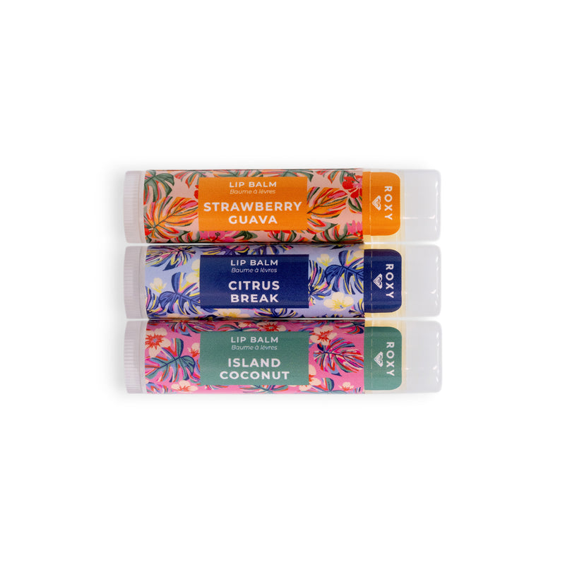 The Roxy Lip Balm Set features three tubes—Strawberry Guava, Citrus Break, and Island Coconut—with vibrant tropical designs, delivering nourishing hydration and a burst of tropical flavor.
