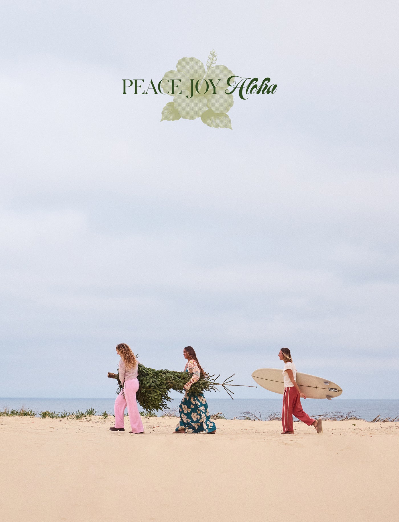 Three people walking on a beach with surfboards and a Christmas tree, with 'Peace Joy Aloha' text above.