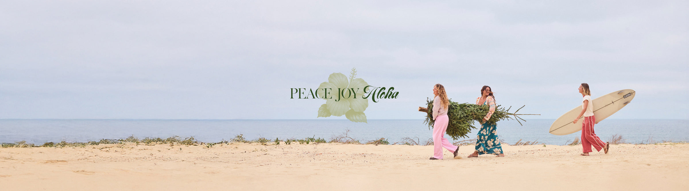 Three women walking on a beach with surfboards, carrying flowers, and the text 'Peace Joy Love' displayed.