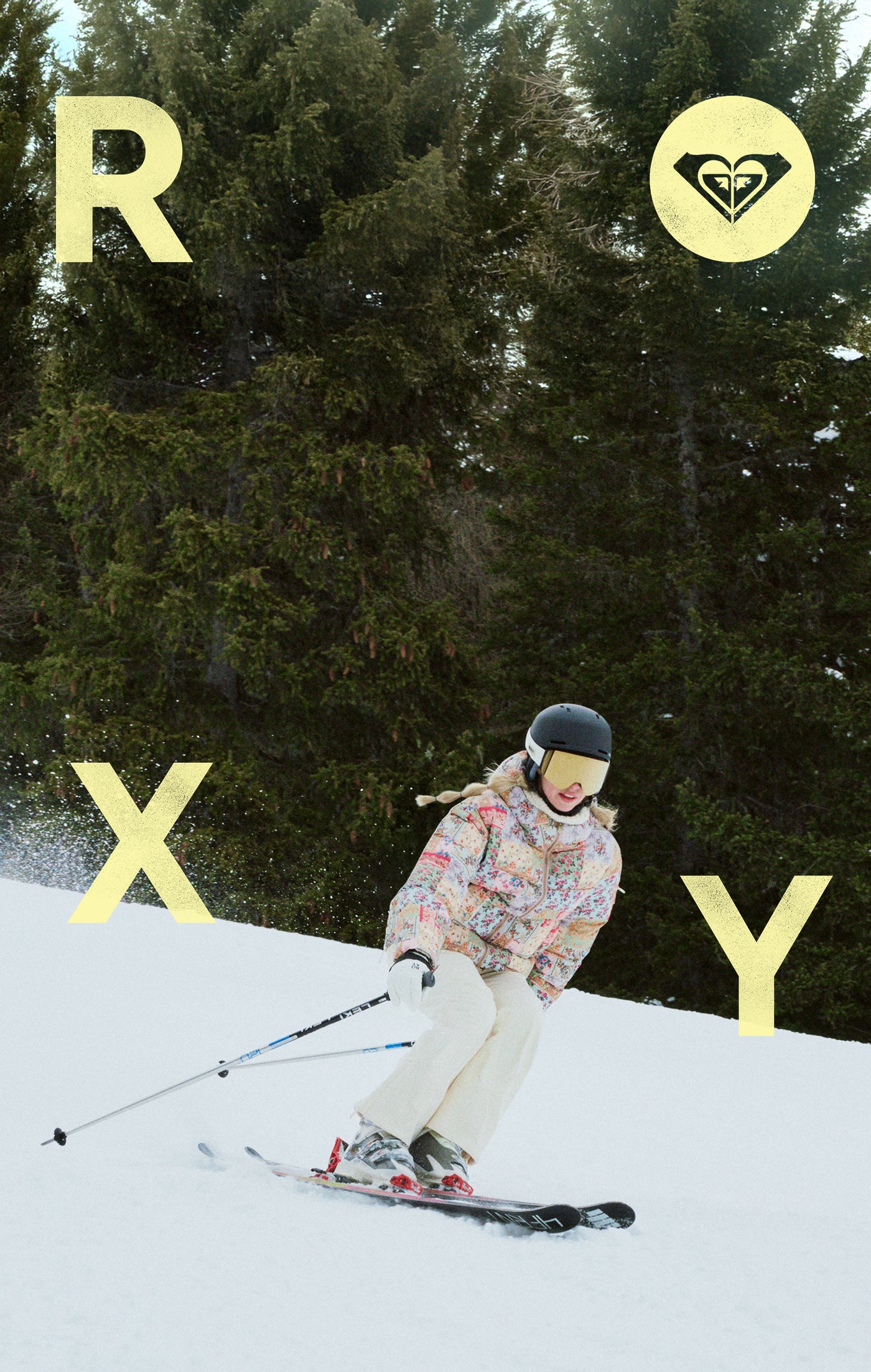 Person skiing on a snowy slope with trees in the background, featuring Roxy branding.