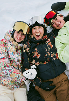 Three people in winter gear posing together outdoors
