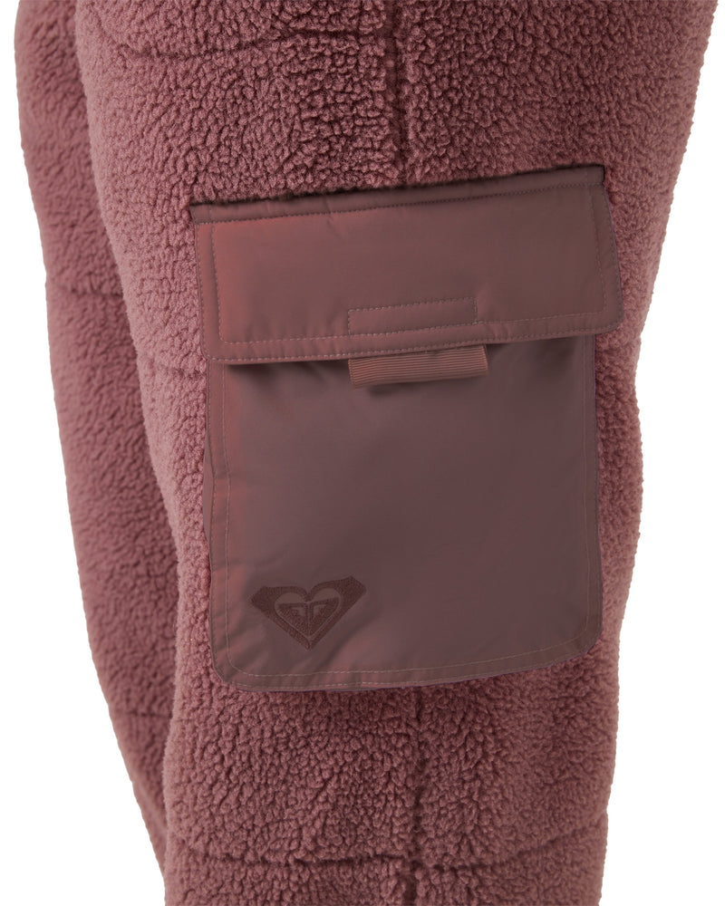 Mauve-colored Roxy Rita Sherpa Jogger fleece pants featuring a large utility pocket on the thigh with a flap closure and an embroidered logo.