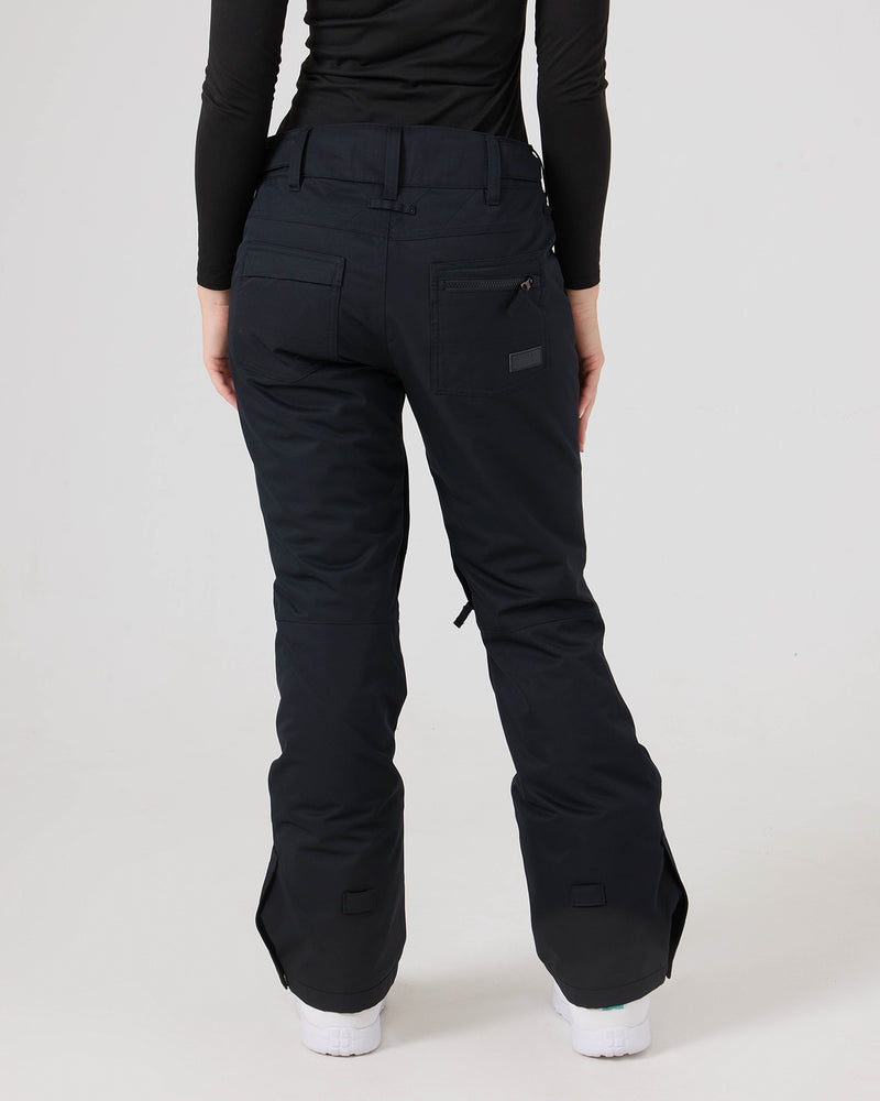 A person is shown from the back, standing against a white background, wearing a black long-sleeve top and the Roxy Nadia Pants—black women’s snow pants crafted from waterproof corduroy fabric.