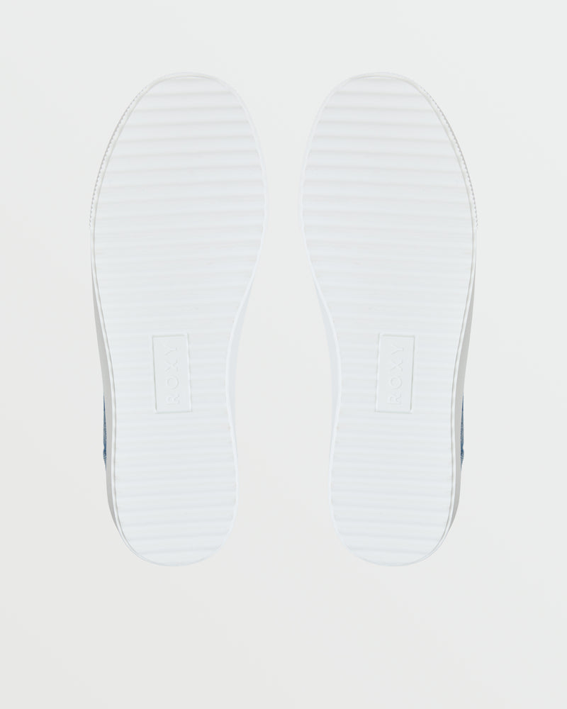 The Shorebreak Slip On Sneaker by Roxy features white soles with a subtle horizontal striped texture and an embossed rectangular logo at the center, displayed against a plain white background.