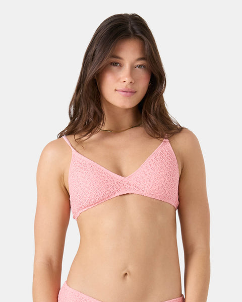 A woman with long brown hair wears the Roxy Crochet Athletic Triangle Bikini Top, featuring adjustable straps. She stands against a plain light background and looks at the camera with a neutral expression.