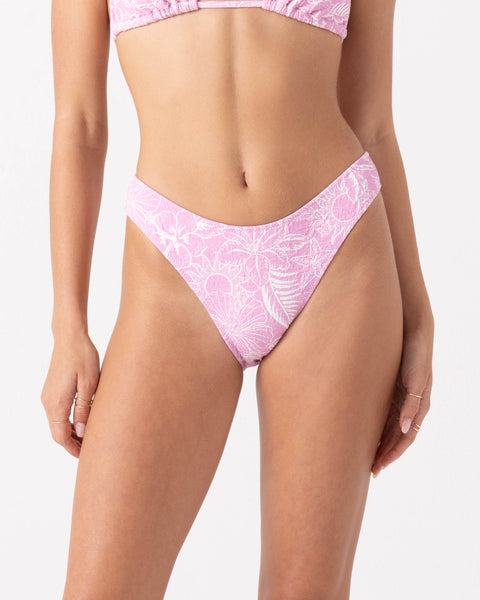 A person wears the Bora Bora Scoop Cheeky Bikini Bottom by Roxy in Pastel Lavender, featuring a white floral print and recycled fabric, shown from mid-torso to upper thighs against a plain white background.