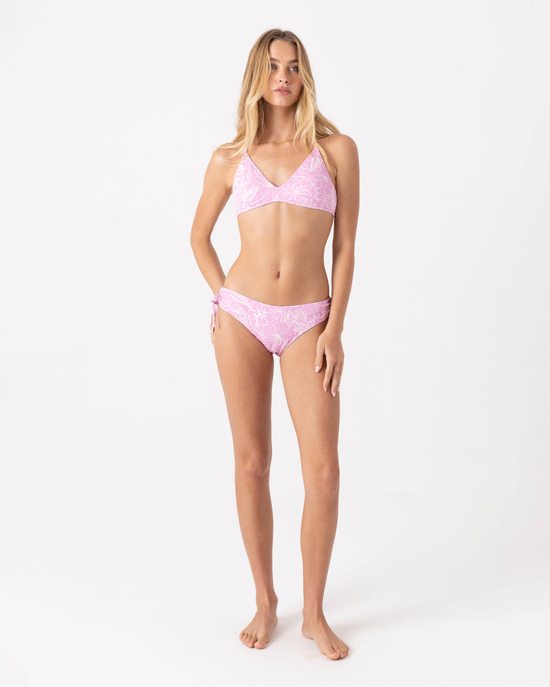 A woman stands on a white background wearing the Roxy Bora Bora Hipster Lace Full Bikini Bottom, featuring adjustable tie sides, facing forward with her arms relaxed at her sides.