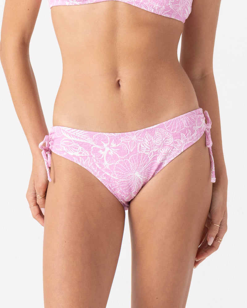 A person wears Roxy’s Bora Bora Hipster Lace Full Bikini Bottom in Pastel Lavender, shown from mid-torso to upper thighs against a plain background.