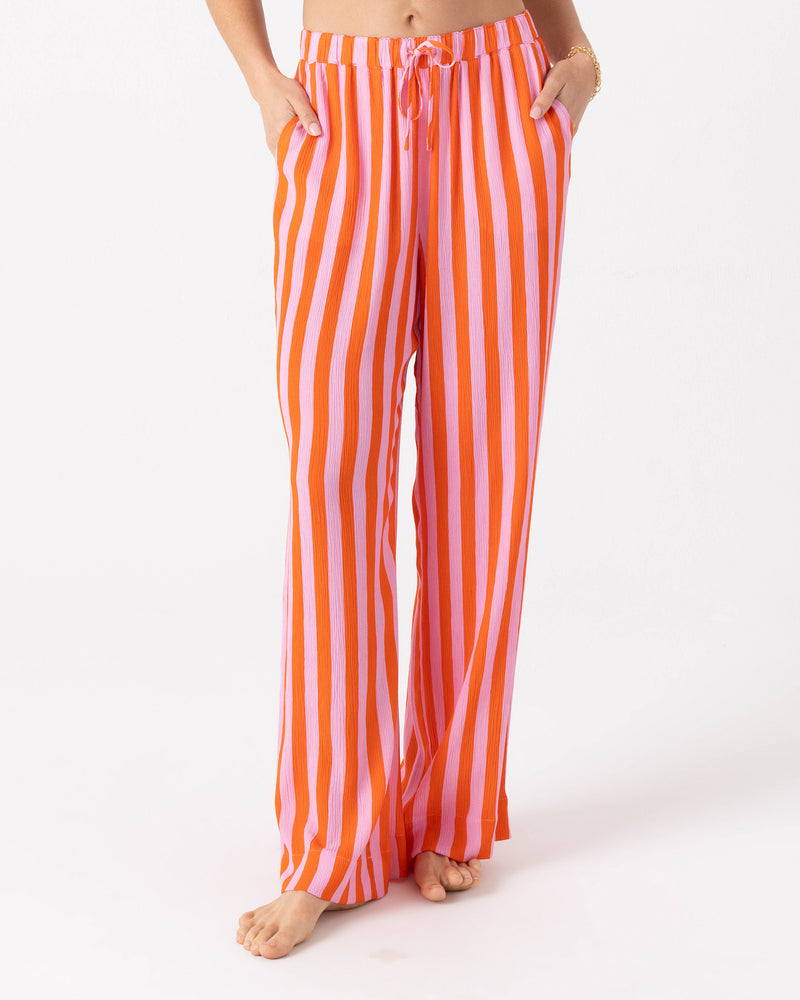 Roxy Ya Stripe Me Crazy Beach Pant featuring wide legs, a vertical pink and orange striped pattern, and a drawcord elastic waist.