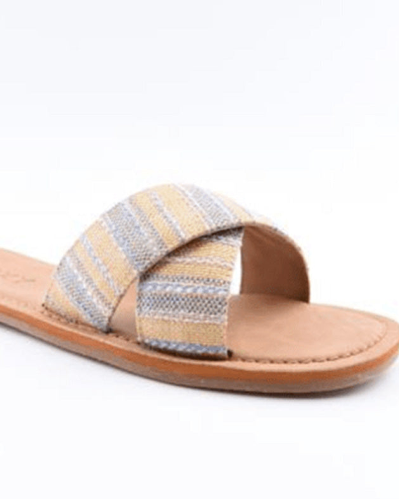 The Roxy Andreya Sandal features a tan flat sole and a wide crisscross fabric strap with blue, gray, and beige stripes, shown on a white background.