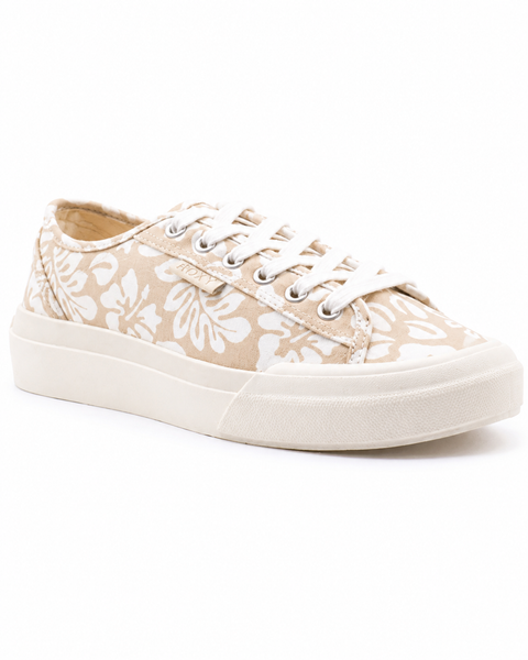 The Roxy Marina Sneaker for women features beige canvas with white floral patterns, white laces, metal eyelets, and a thick white rubber sole, shown from a slight angle on a white background.