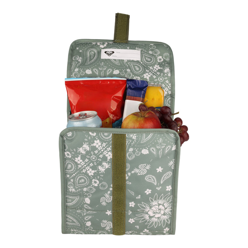 A delightful green Smiling Seagulls Lunch Bag by Roxy, featuring a playful white floral print and packed with a can, a red snack bag, a granola bar, an apple, cheese, and a bunch of grapes.