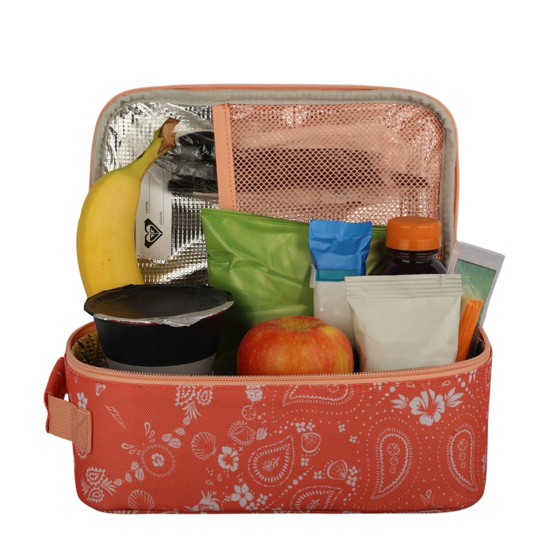 The open Groovy Life Lunch Bag by Roxy, featuring a pink paisley pattern, holds a banana, an apple, yogurt, juice, bottled water, and various packaged snacks—all neatly arranged inside.