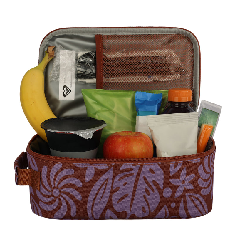 The Roxy Groovy Life Lunch Bag features a stylish floral pattern and includes a silver cooler lining and a mesh pocket inside the lid to keep your lunch organized. It can hold items such as a banana, an apple, a yogurt cup, juice, green and white packets, and various snacks.