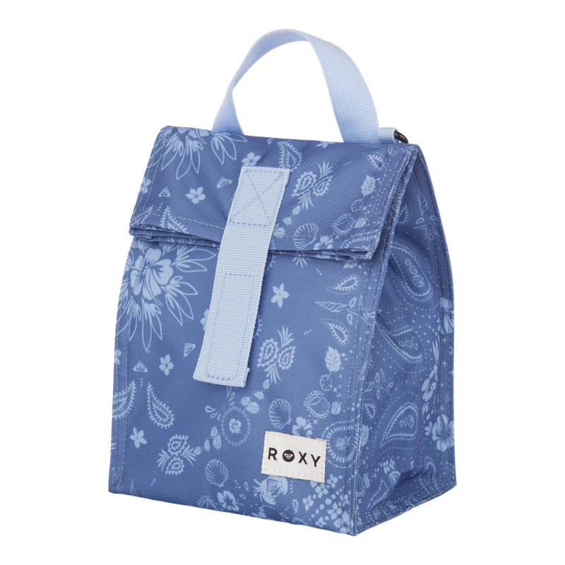 The Roxy Lunch Hour Lunch Bag features a blue design with a white floral and paisley pattern, a light blue handle, a front flap secured by velcro, and a white Roxy logo patch at the bottom.