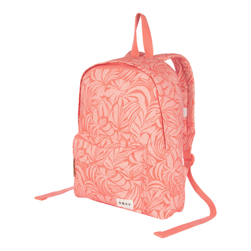 Coral pink ROXY Sugar Baby Canvas Backpack featuring a leafy pattern, front zip pocket, and adjustable straps. Made from recycled cotton for eco-conscious fashion lovers, with the ROXY brand label displayed on the lower front pocket.