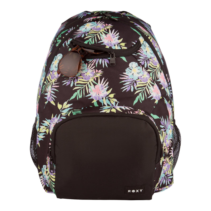 A black floral ROXY Shadow Swell Backpack with a front pocket featuring the ROXY logo and a pair of sunglasses tucked into the smaller upper pocket.
