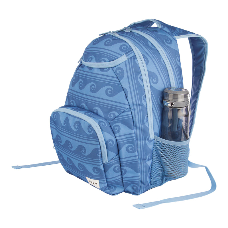 The ROXY Shadow Swell Backpack features a blue design with wavy stripe patterns, a spacious front pocket, and includes a black reusable water bottle tucked into the side mesh pocket.