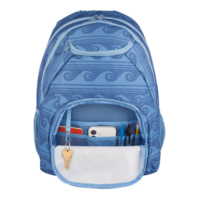The ROXY Shadow Swell Backpack features a blue wave pattern, with its front pocket open to reveal pens, a phone, and a notebook inside, along with a set of keys hanging on the built-in hook.