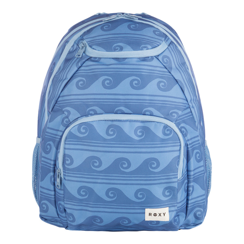 The ROXY Shadow Swell Backpack features a blue design with light blue wave patterns, a front zippered pocket, side mesh pockets, and a white ROXY label on the bottom front.