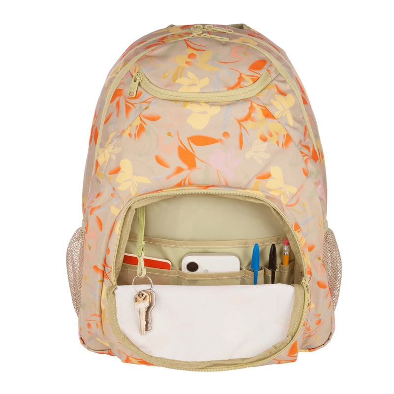 The ROXY Shadow Swell Backpack, featuring a floral design, is shown with its front pocket open to reveal neatly organized keys, pens, a pencil, a mobile phone, and a notepad inside.