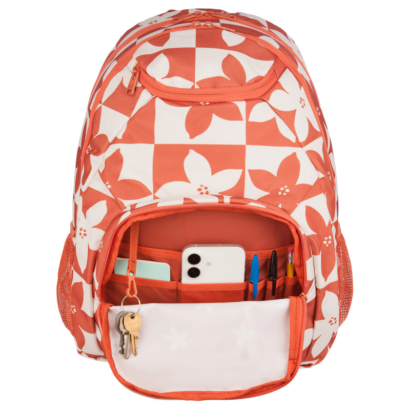 A ROXY Shadow Swell Backpack in a red and white checkered design with floral patterns. Its open front pocket reveals keys, a phone, pens, markers, and a notepad neatly organized inside.