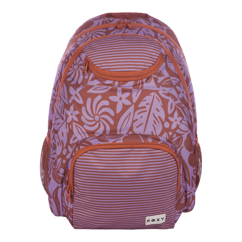 The Roxy Shadow Swell Backpack features a purple and brown color scheme with floral and striped patterns, front zippered pockets, side mesh pockets, and a ROXY label on the lower front pocket.