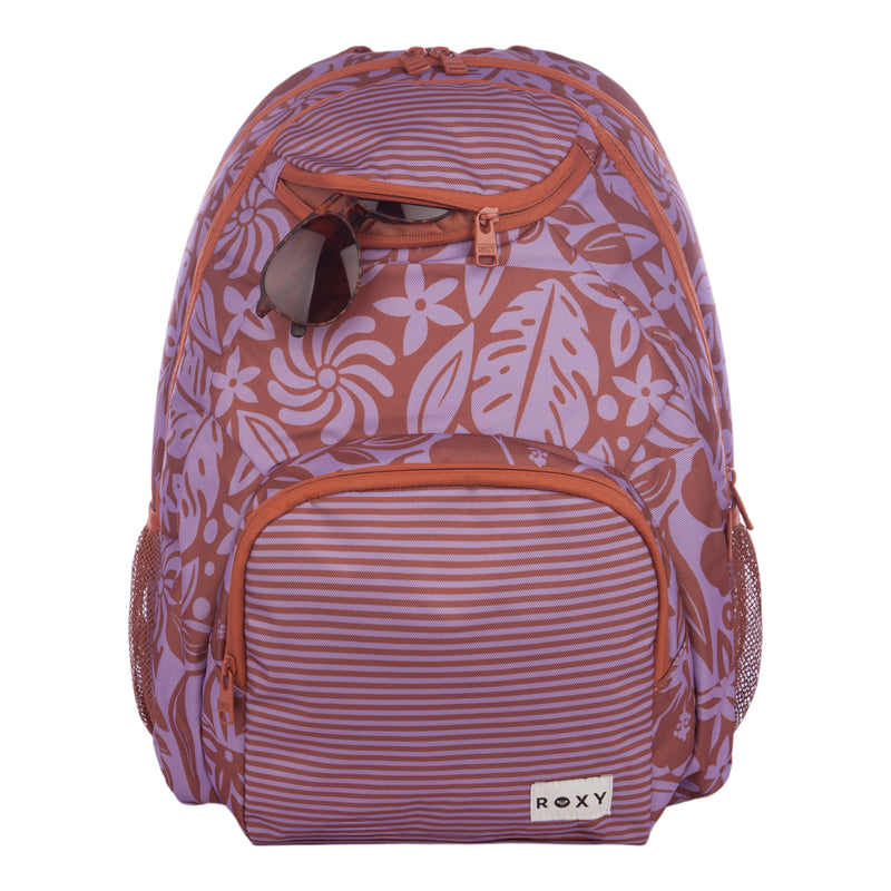 A purple and brown floral-patterned Roxy Shadow Swell Backpack with sunglasses tucked into the front pocket.