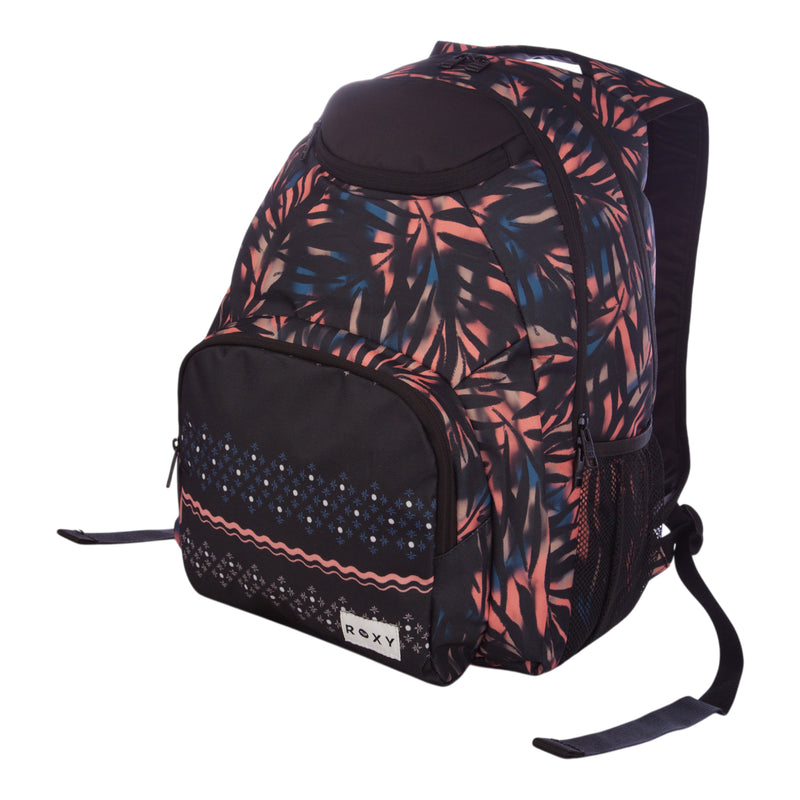 The Roxy Shadow Swell Backpack features a leaf pattern in pink, blue, and black, a front zip pocket with decorative trim, and side mesh pockets.