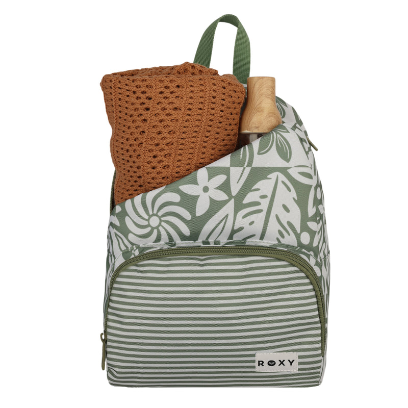 A green and white floral-patterned Always Core Printed Backpack by Roxy, featuring a striped front pocket, holds a folded orange crochet sweater and a wooden item—possibly a handle or small stick—protruding from the top pocket.