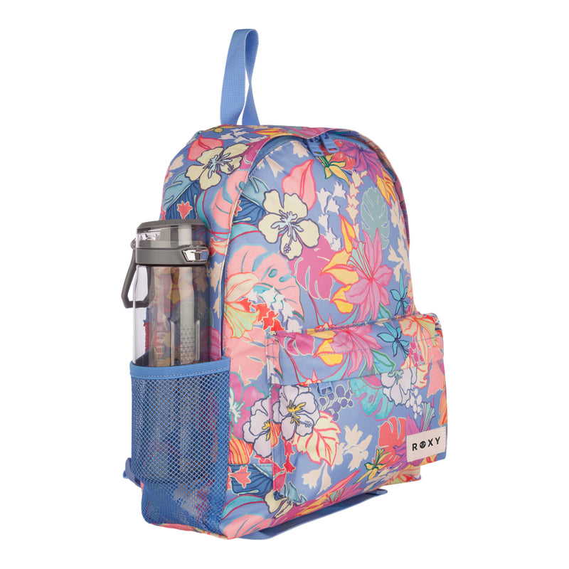 A sustainable ROXY Sugar Baby Bottle Backpack, crafted from recycled polyester, featuring a vibrant blue, pink, orange, and yellow floral pattern. This colorful backpack includes a front pocket, blue straps, and a mesh side pocket holding a clear water bottle.