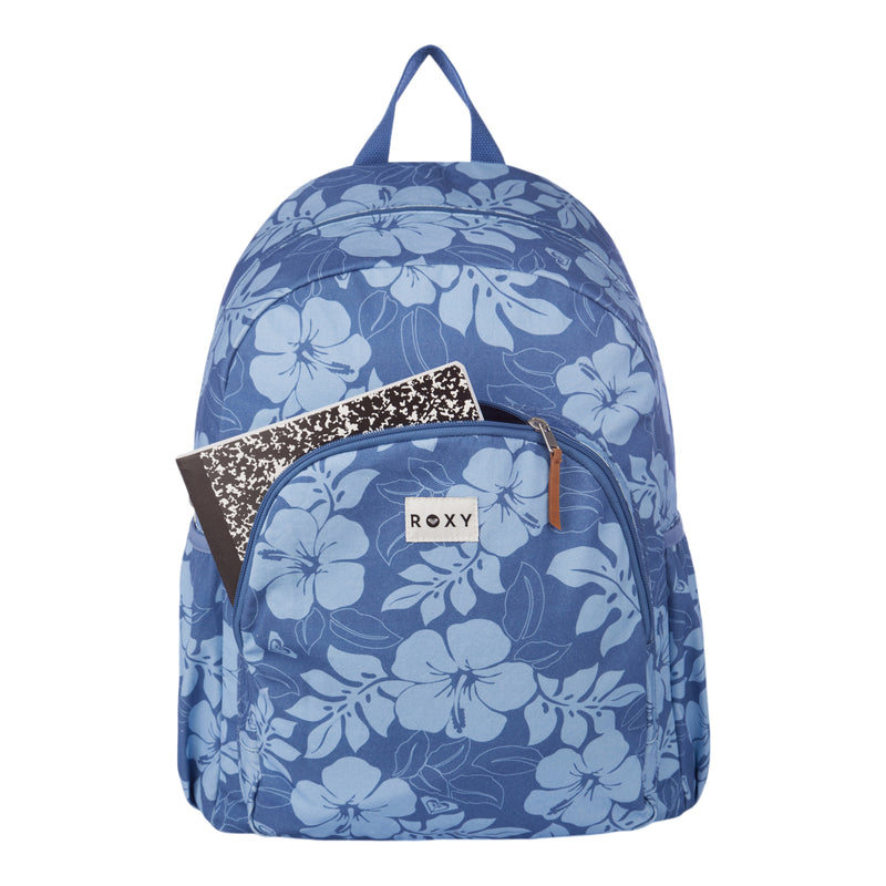 The Roxy Moon Magic Backpack, featuring a blue floral design and a front pocket, is shown with two composition notebooks inside—one in black-and-white and one in black. The backpack includes a top handle and displays the Roxy label. The background is plain white.