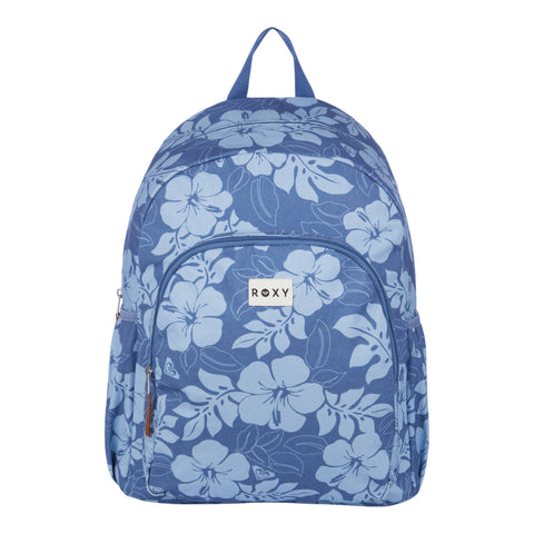 The Roxy Moon Magic Backpack features a blue design with light blue floral patterns, a front zipper pocket, side pockets, a top handle, and a white Roxy label on the front.